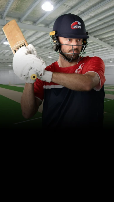 Professional cricket player in training stance at Century Cricket center - mobile hero image